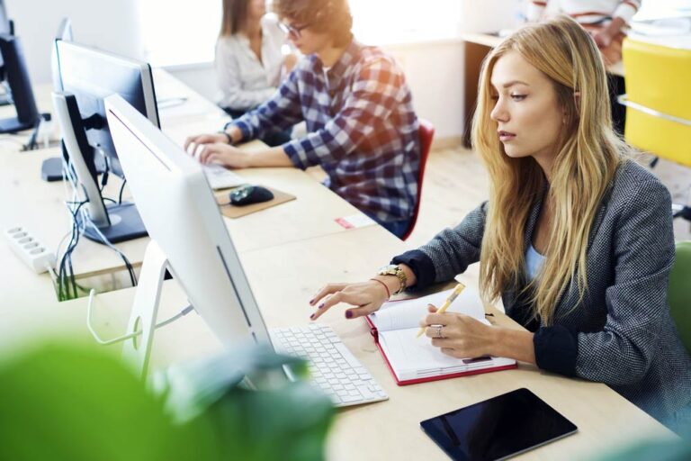 female employing working at desk with computer