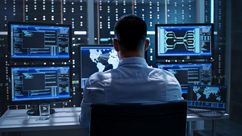 security engineer looking at data dashboard screens