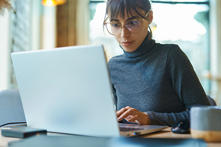 professional lady working on assessments on a laptop